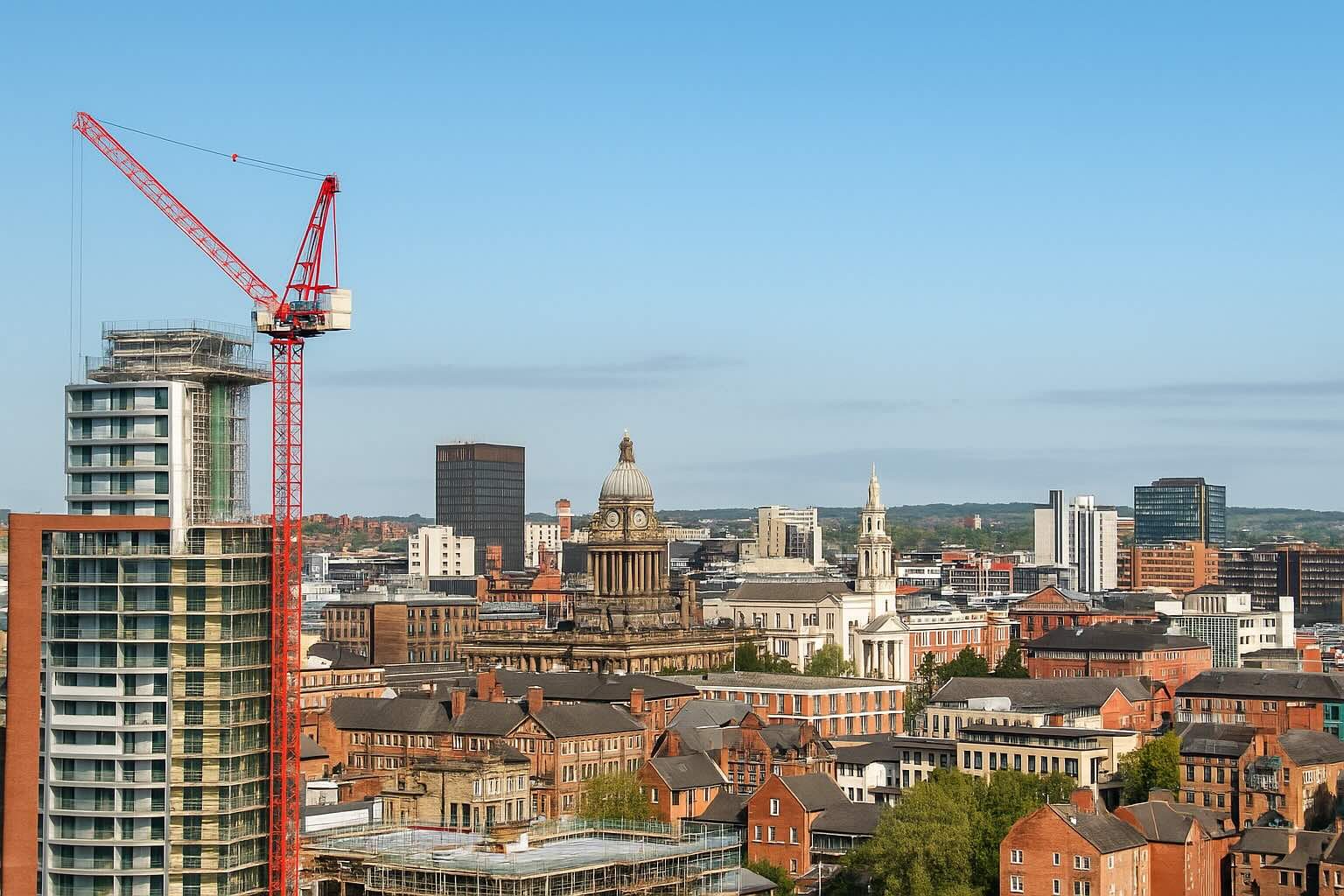 Leeds city skyline with construction cranes and modern buildings — professional health and safety consultancy site view.